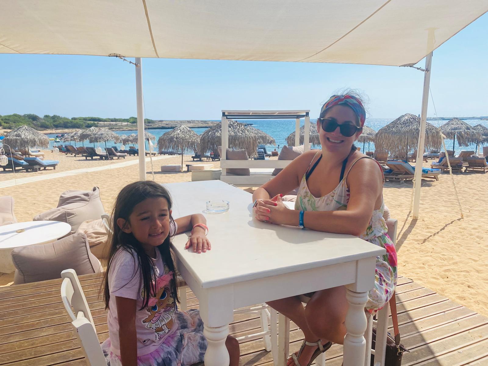 Adult and child at table sitting on beech